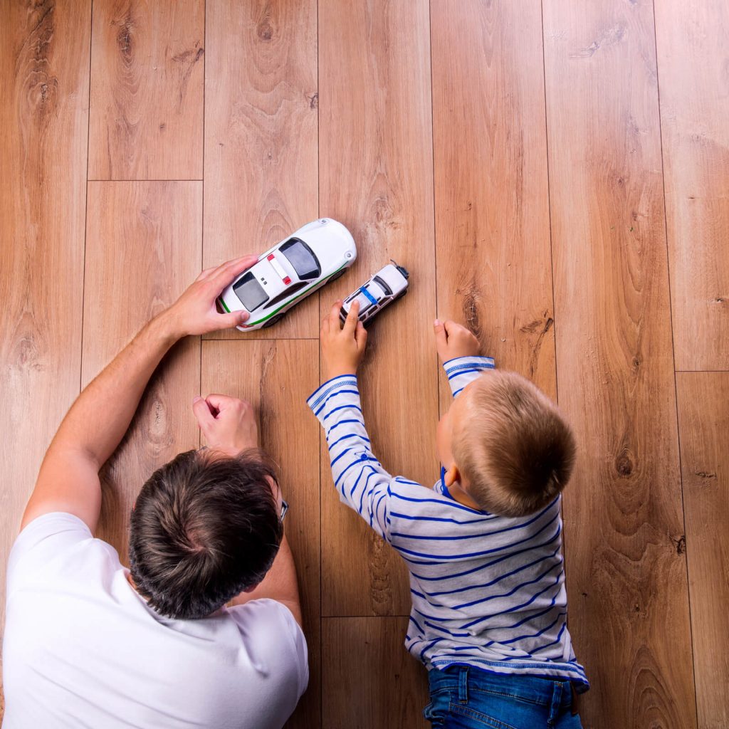 Father with kid playing with toycar | Gilman Floors