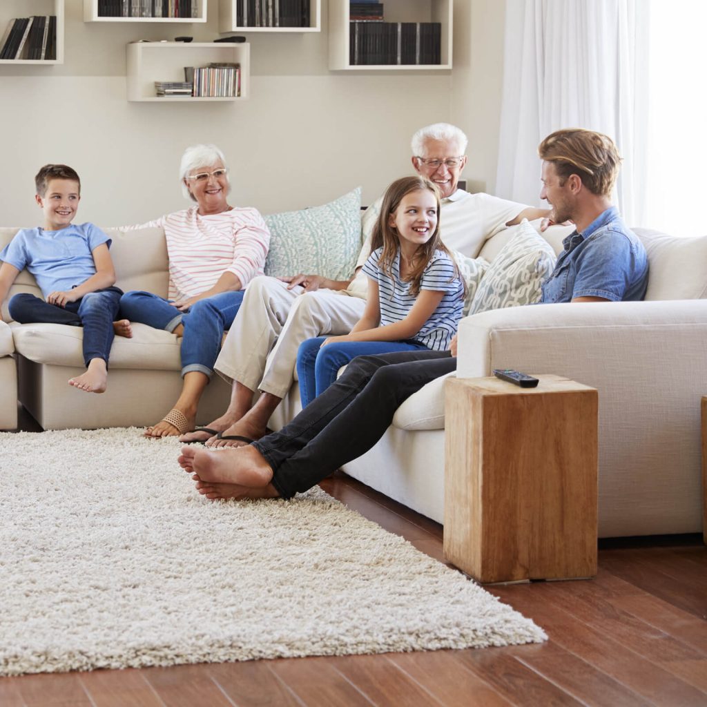 Family spending time together in living room | Gilman Floors