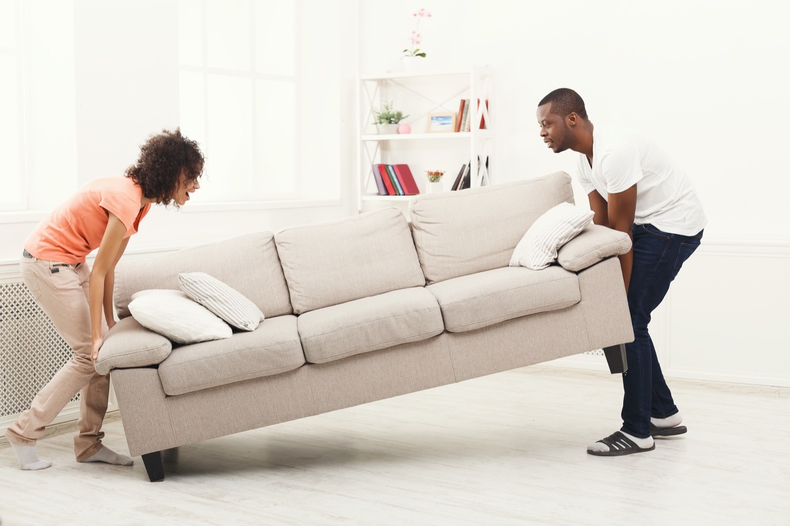 Couple moving couch | Gilman Floors