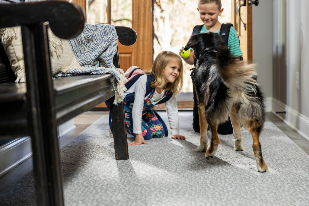Kids playing with dog | Gilman Floors